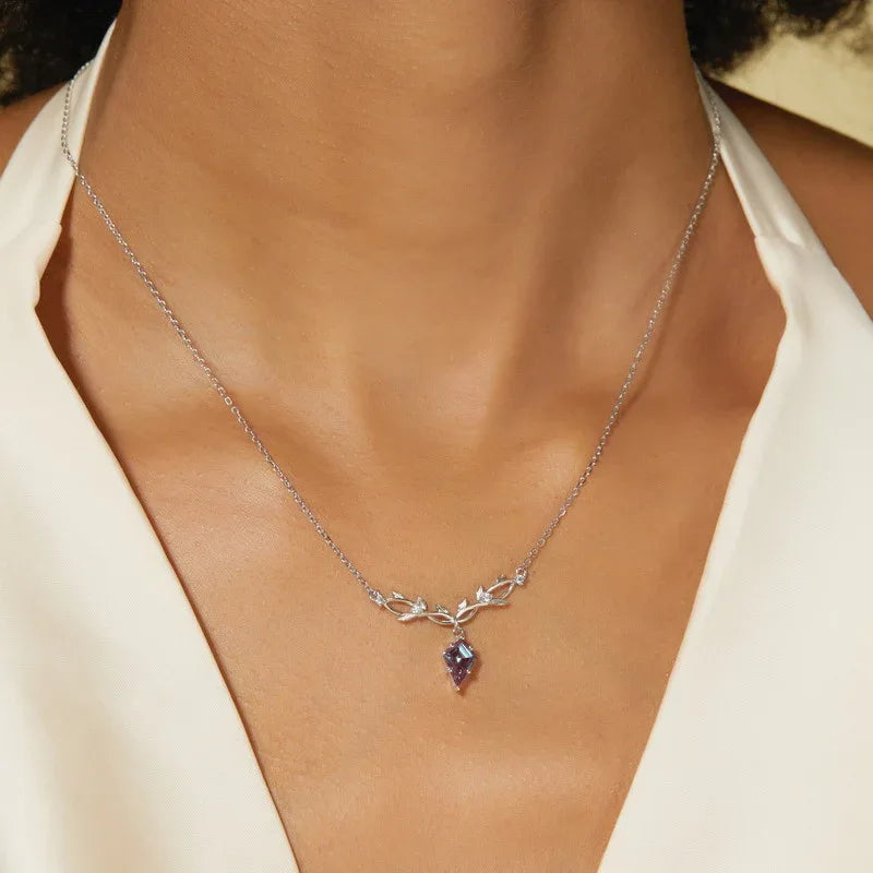 Kite-cut Alexandrite leaf collar necklace, shown worn in a close lifestyle view