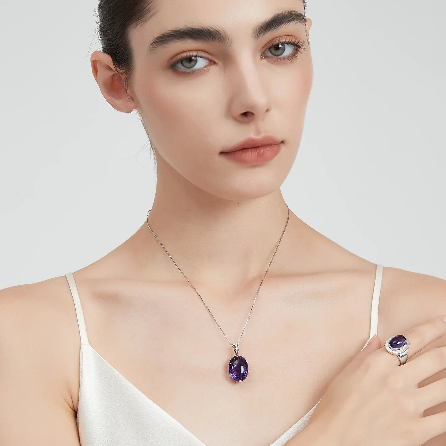 large oval amethyst pendant necklace second neckline view in soft light