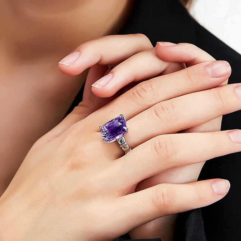 rectangular amethyst solitaire ring worn on the hand from a second angle