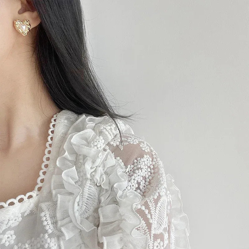 Molten-Texture Heart Pearl Stud Earrings — left-ear worn portrait showing the stud scale