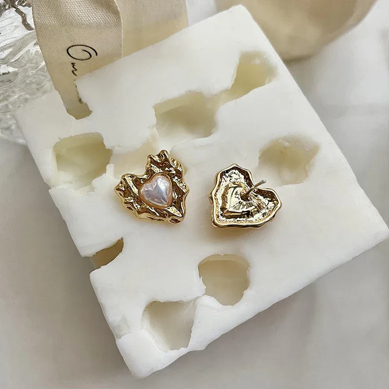 Molten-Texture Heart Pearl Stud Earrings — alternate display showing the textured frames and backs