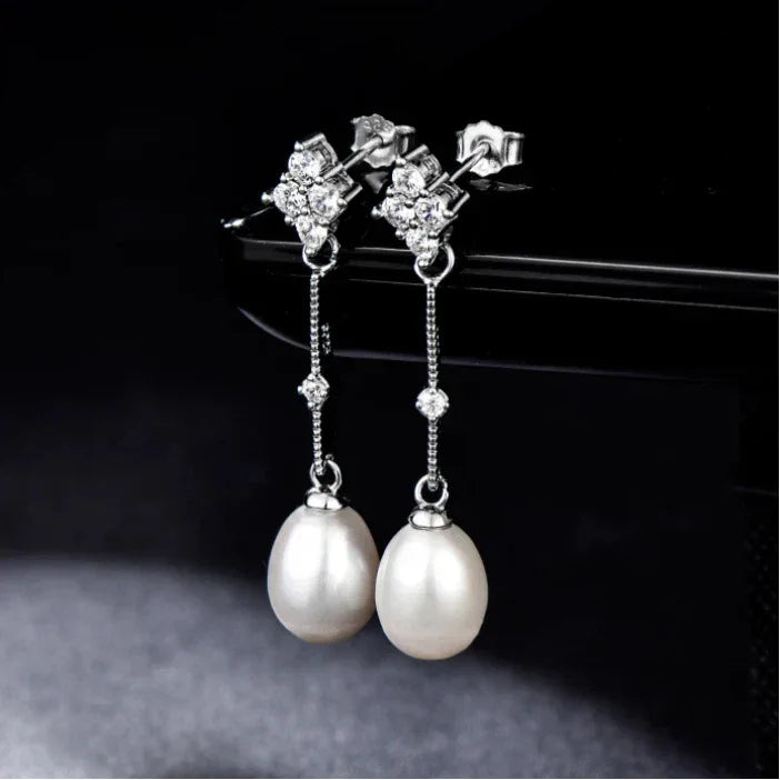 Teardrop Pearl Linear Earrings in Platinum-Plated S925 Silver — pair suspended against a black background