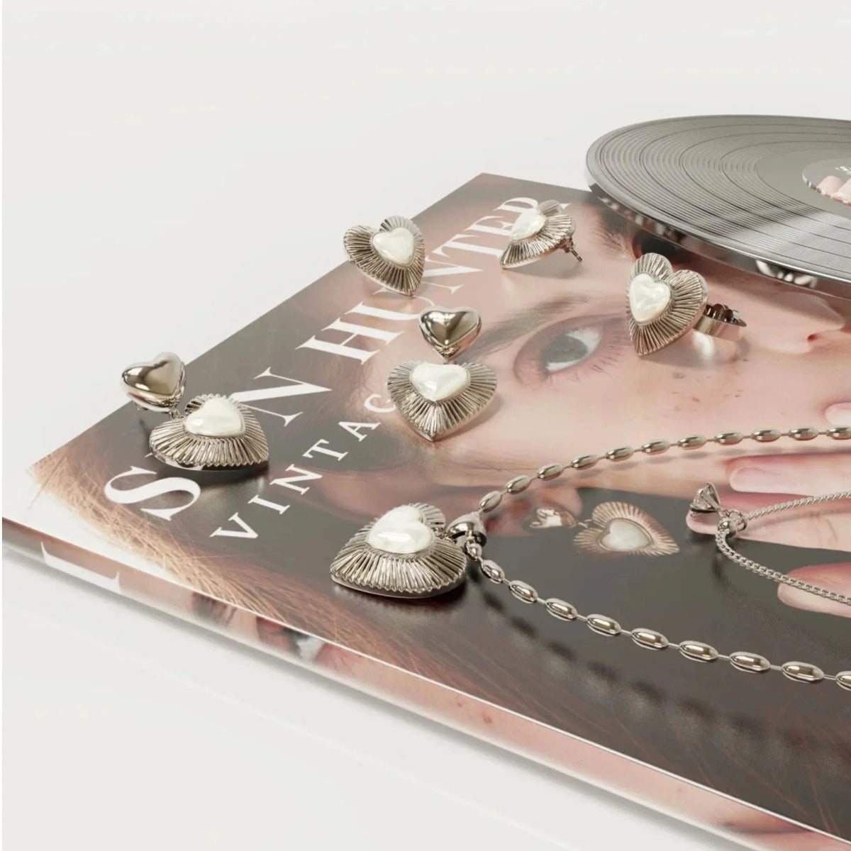 Double-Layer Pearl Heart Necklace — coordinated jewelry display on a book and tray
