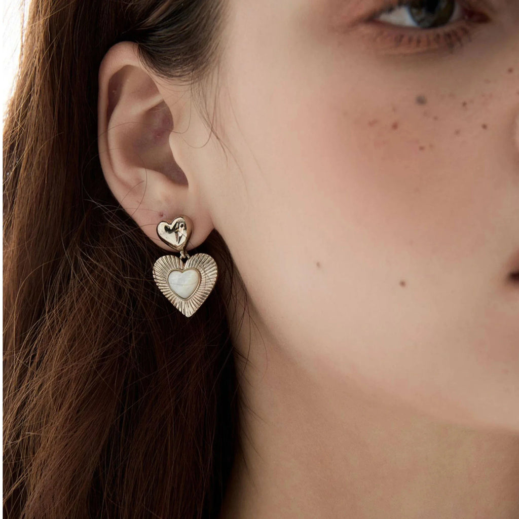 Double-Heart Pearl Drop Earrings — right-ear worn close-up showing the two-heart drop scale