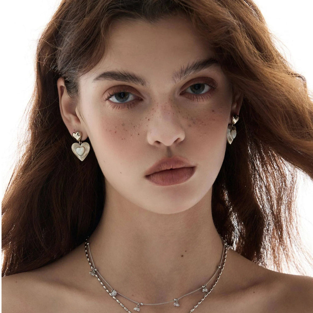 Double-Heart Pearl Drop Earrings — front model portrait wearing the earrings