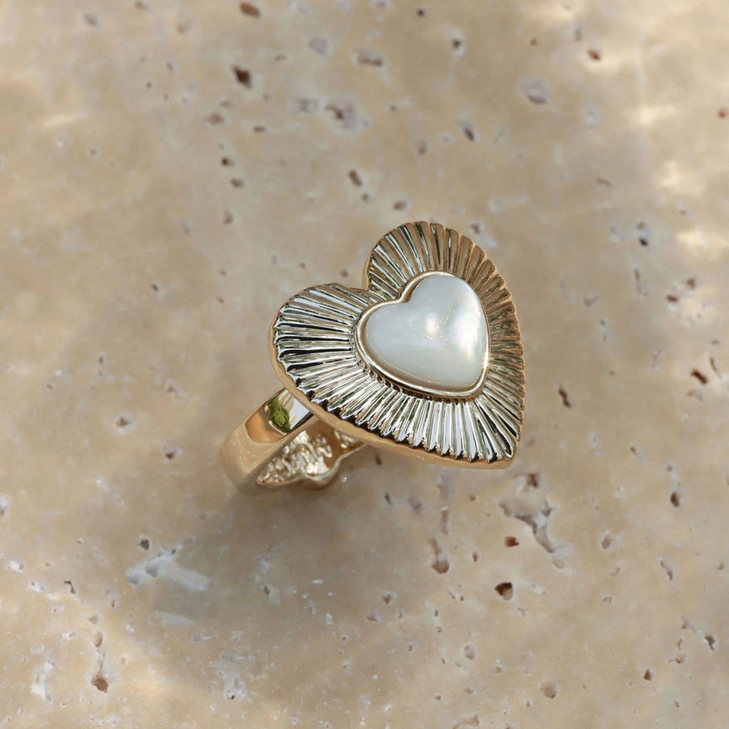 Ridged Pearl Heart Open Ring — top view on a pale stone surface