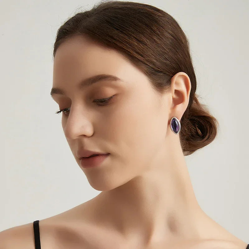 marquise amethyst stud earrings styled portrait showing the earrings for scale