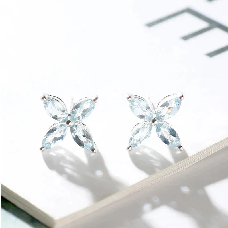 Marquise Aquamarine Four-Petal Stud Earrings angled pair on a white background