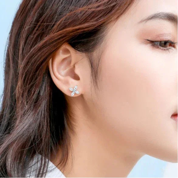 Marquise Aquamarine Four-Petal Stud Earrings worn on the ear from a second angle