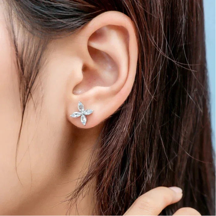 Marquise Aquamarine Four-Petal Stud Earrings worn on the ear in a close-up