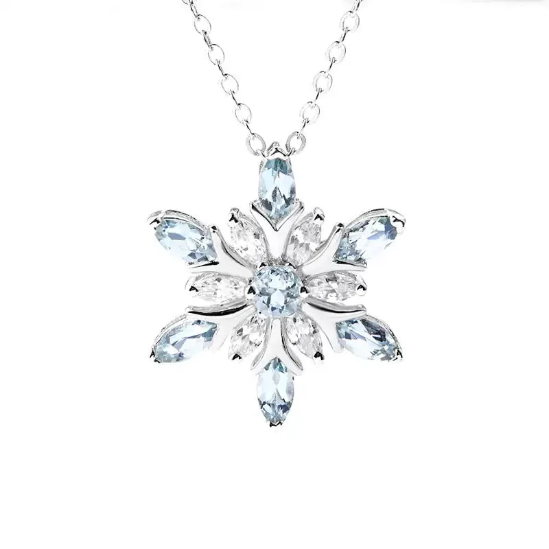 Marquise Aquamarine Snowflake Pendant Necklace pendant and chain detail on a light background