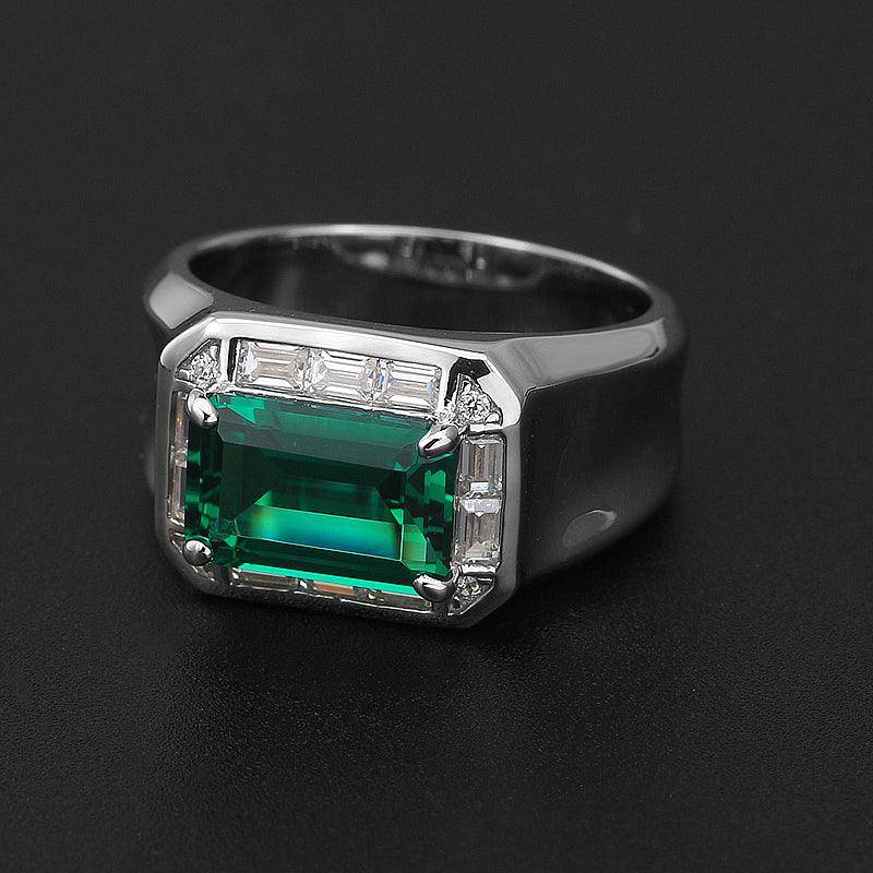 Men's Elongated Emerald Halo Ring angled product view on a dark background