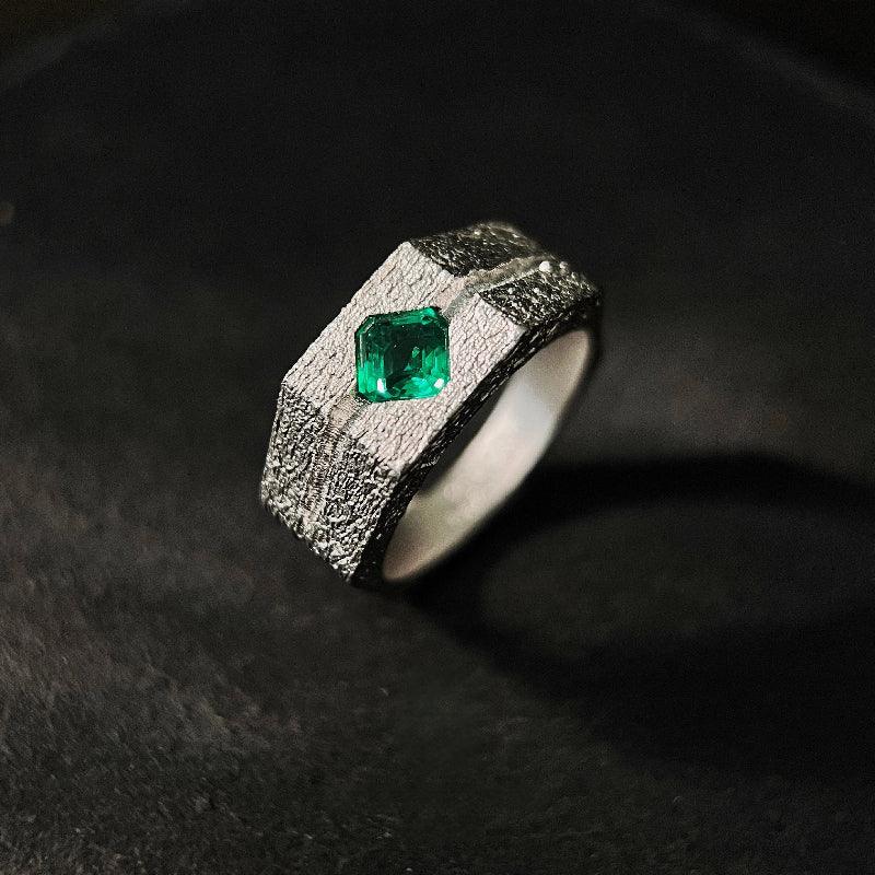 Men's Emerald Textured Signet Ring angled product view on a dark background