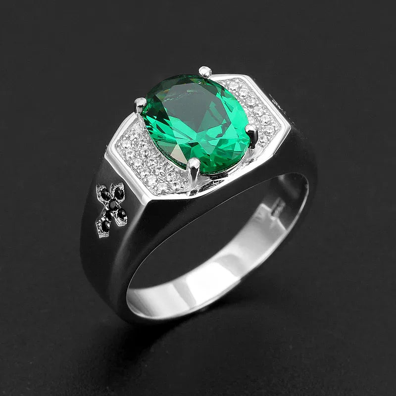 Men's Oval Emerald Fleur-de-Lis Ring angled product view on a dark background