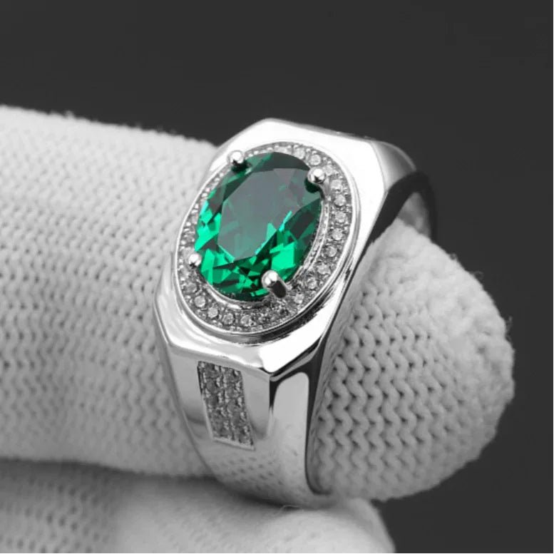 Men's Oval Emerald Halo Ring angled product view on a dark background