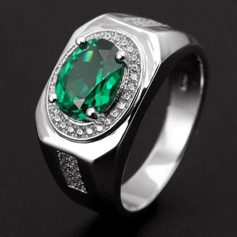 Men's Oval Emerald Halo Ring worn on the hand in a close-up