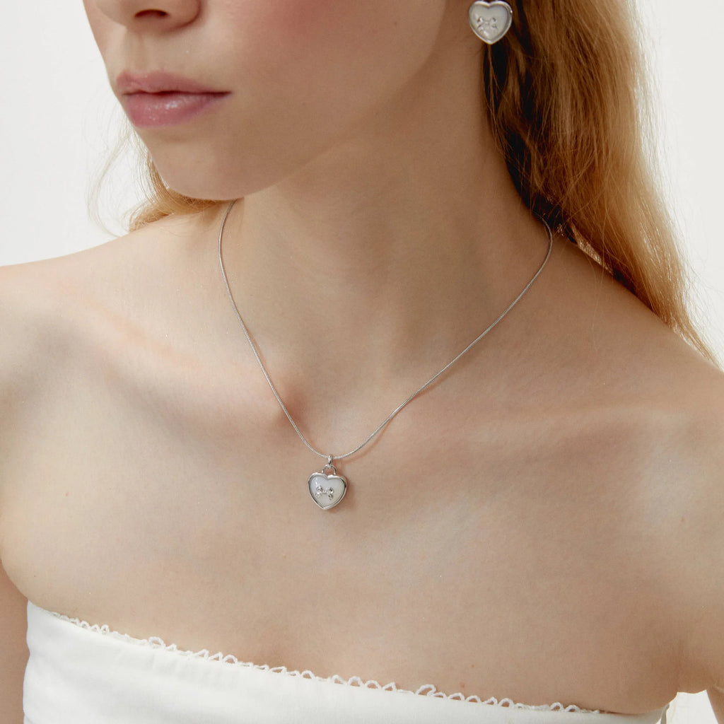 Pearl Heart Pendant Necklace with Bow Detail — side neckline-worn portrait