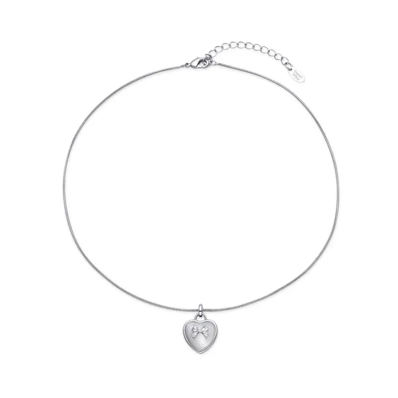Pearl Heart Pendant Necklace with Bow Detail — isolated full necklace view with extension chain