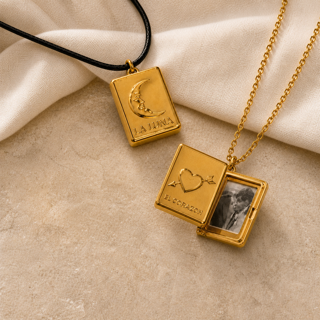 Gold-tone moon and heart locket necklace pair with one photo compartment open on beige stone