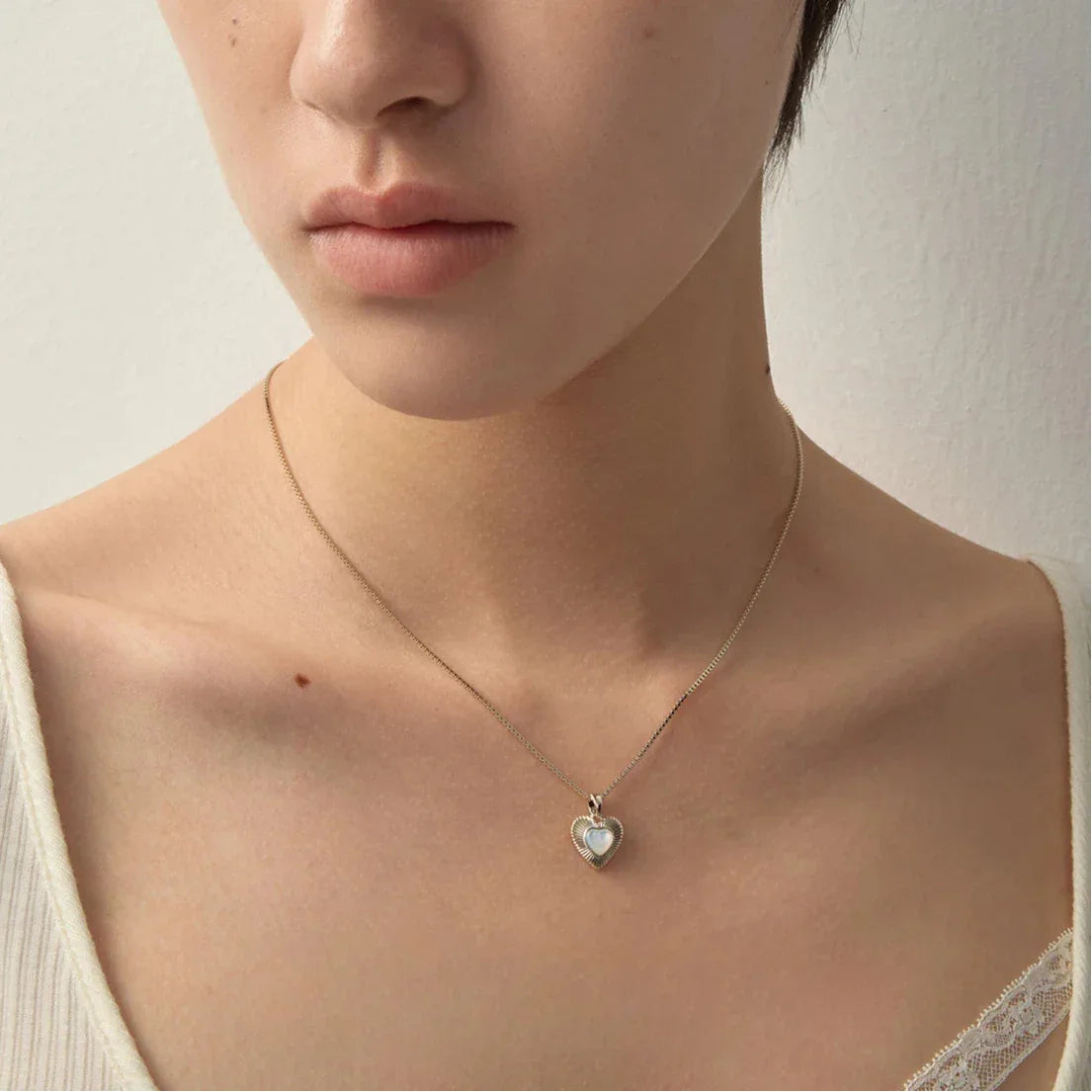Ridged Pearl Heart Pendant Necklace — front portrait showing the pendant scale