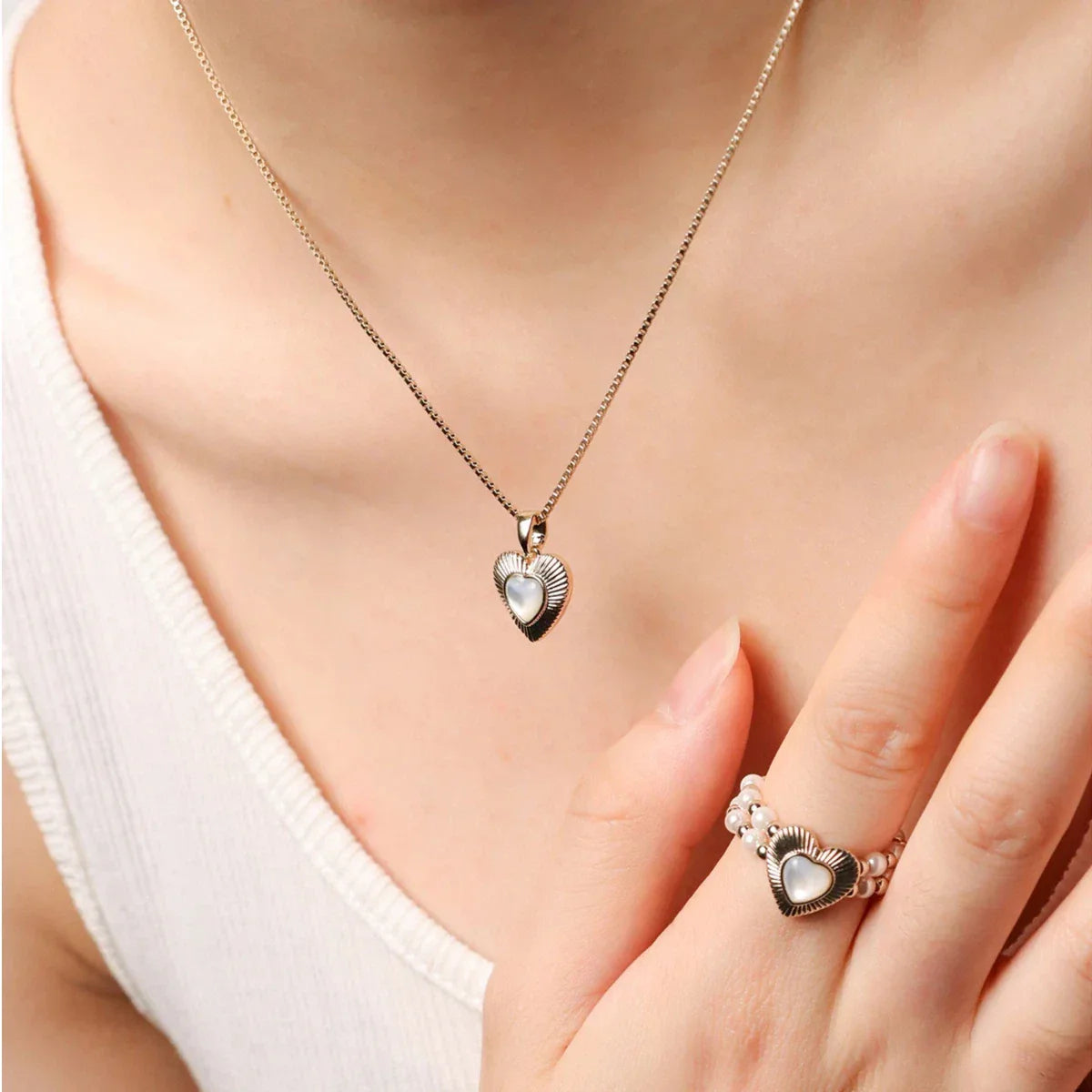Ridged Pearl Heart Pendant Necklace — worn view coordinated with a matching ring