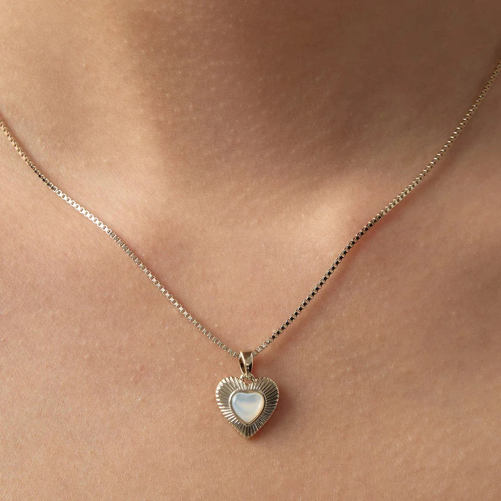 Ridged Pearl Heart Pendant Necklace — neckline-worn close-up over bare skin