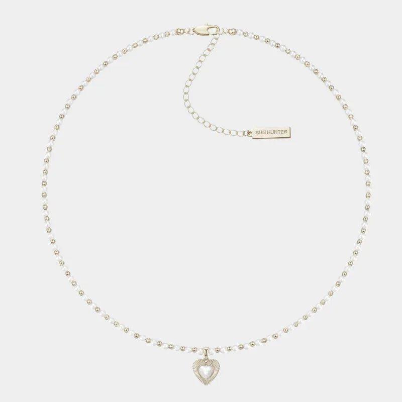Pearl Bead Necklace with Petite Ridged Heart — front view of small pearl bead necklace with a petite heart center