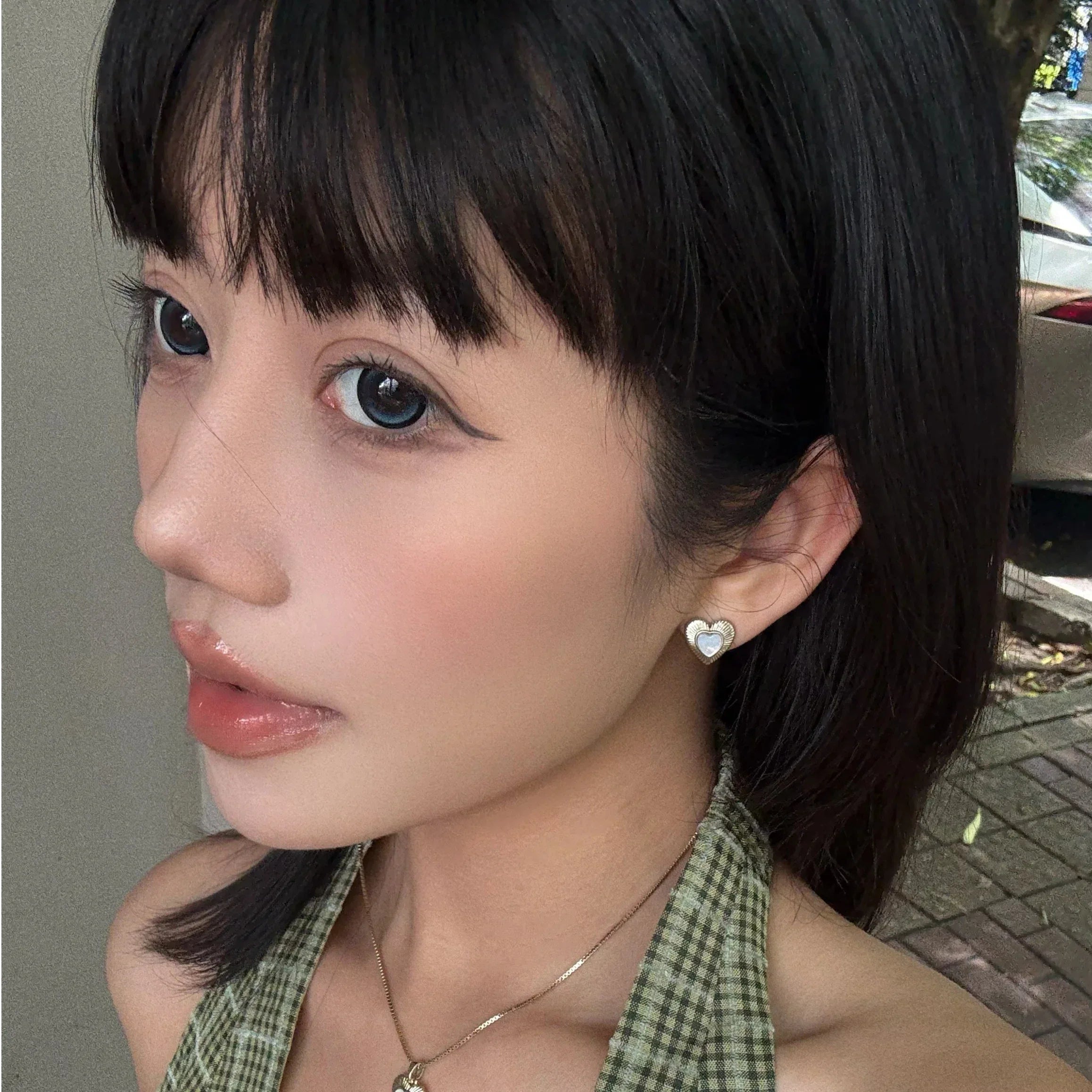 Petite Ridged Pearl Heart Stud Earrings — alternate portrait wearing the studs