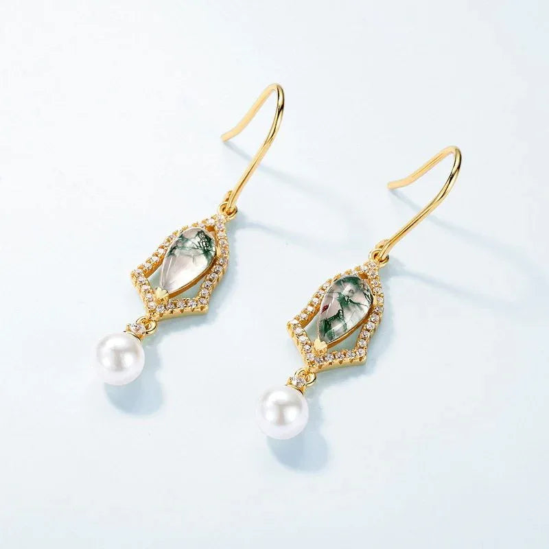 Teardrop Moss Agate Earrings with White Bead Drops — angled pair on a pale blue background
