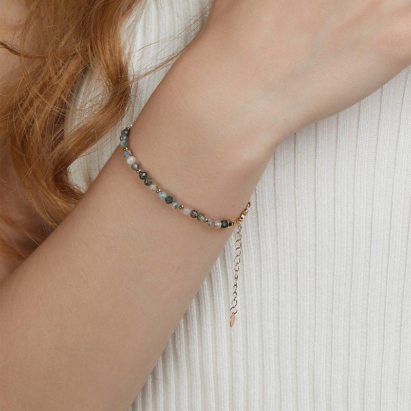 Moss Agate and White Bead Bracelet — wrist-worn view showing the asymmetrical color split