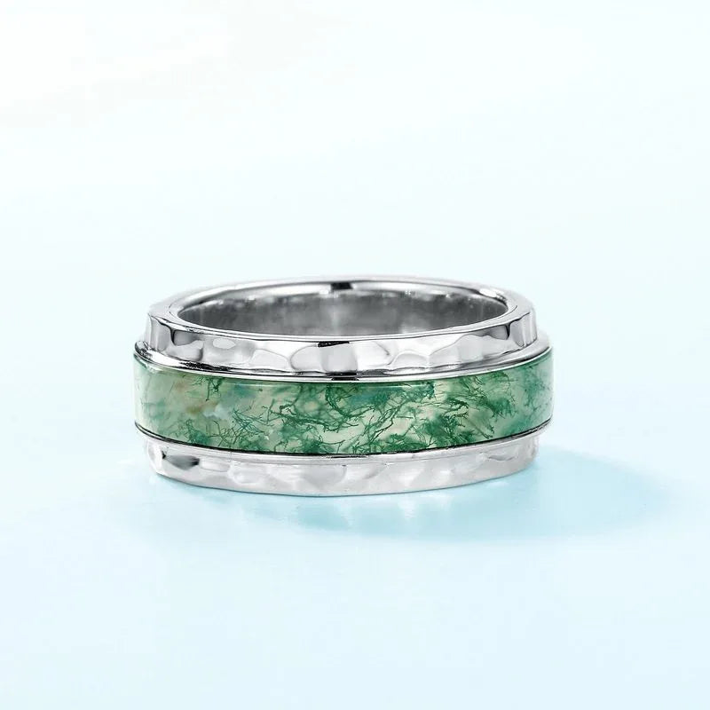 Wide-Band Moss Agate Inlay Ring — upright product view on a pale blue surface