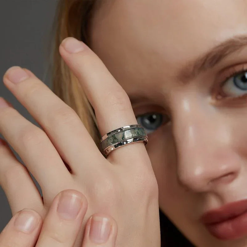 Wide-Band Moss Agate Inlay Ring — ring worn on a finger beside the face