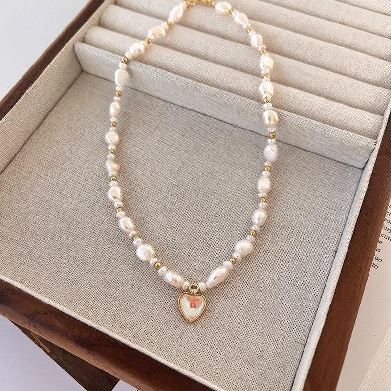 Baroque Pearl Heart Pendant Necklace — necklace displayed in a beige jewelry tray