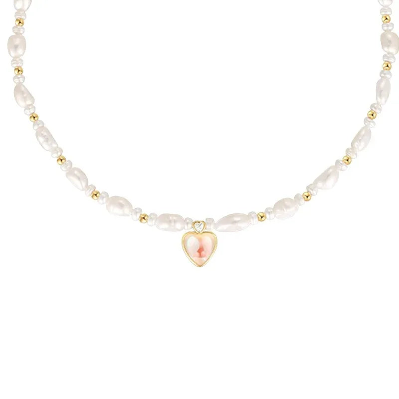Baroque Pearl Heart Pendant Necklace — macro front view of the pearl strand and small heart pendant
