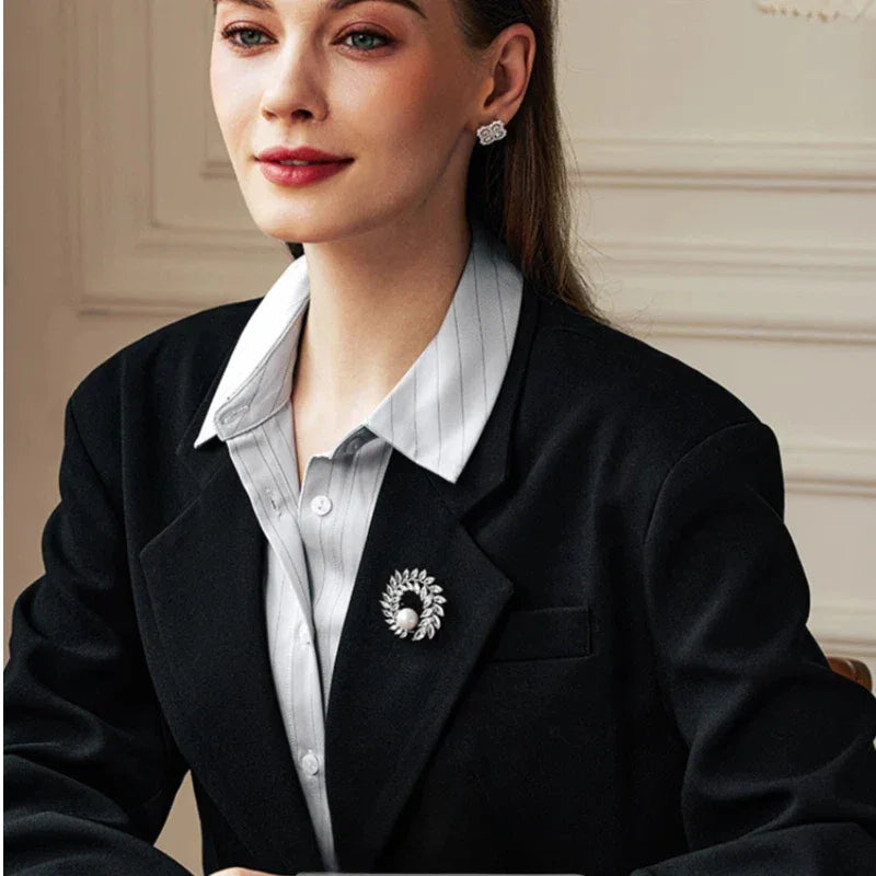 Pearl Olive Wreath Brooch — waist-up model view showing the brooch scale