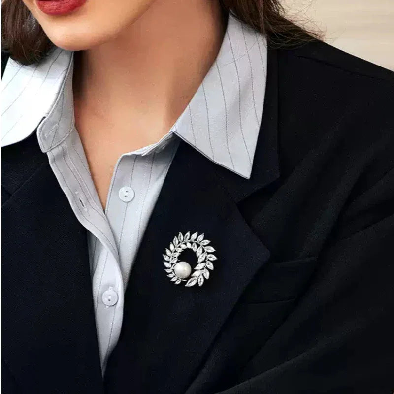Pearl Olive Wreath Brooch — close blazer-worn view showing the brooch at the lapel
