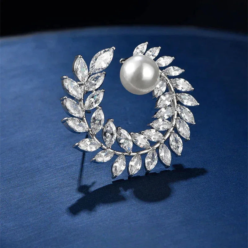 Pearl Olive Wreath Brooch — angled product close-up on a dark surface