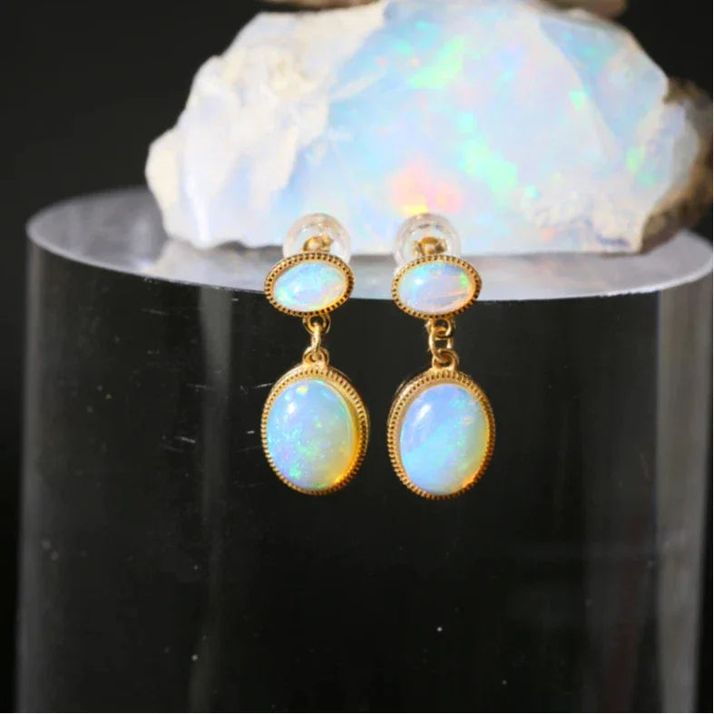Opal Oval Drop Earrings with Round Studs worn on the hand