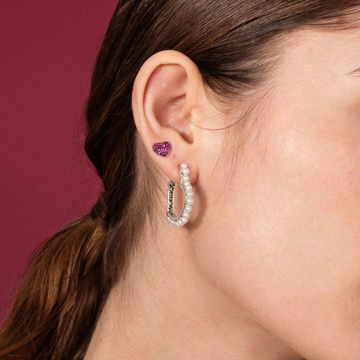 Pearl-Lined Open Heart Earrings — left-ear worn close-up showing the open-heart scale