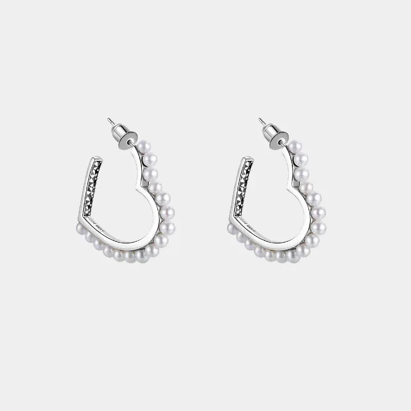 Pearl-Lined Open Heart Earrings — front pair of open heart-shaped earrings lined with small pearls