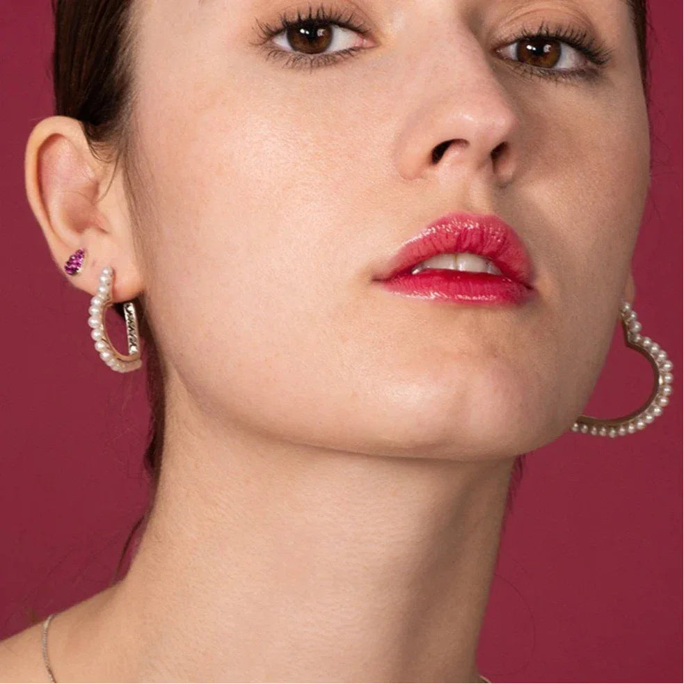 Pearl-Lined Open Heart Earrings — front model portrait wearing the earrings