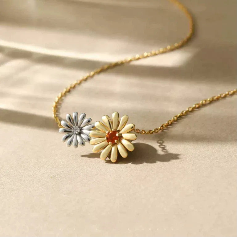 Orange Garnet Two-Tone Floral Necklace pendant styled on a jewelry display