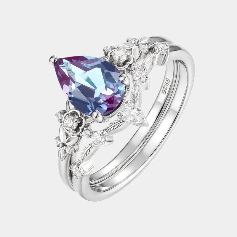 Oval Alexandrite cluster ring with a curved matching band, front product view on a white background