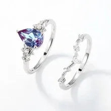 Oval Alexandrite cluster ring with a curved matching band, separated ring set shown on a white background