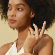 Oval Alexandrite cluster ring with a curved matching band, shown worn by a model for scale