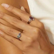 Oval Alexandrite cluster ring with a curved matching band, shown worn in a close lifestyle view
