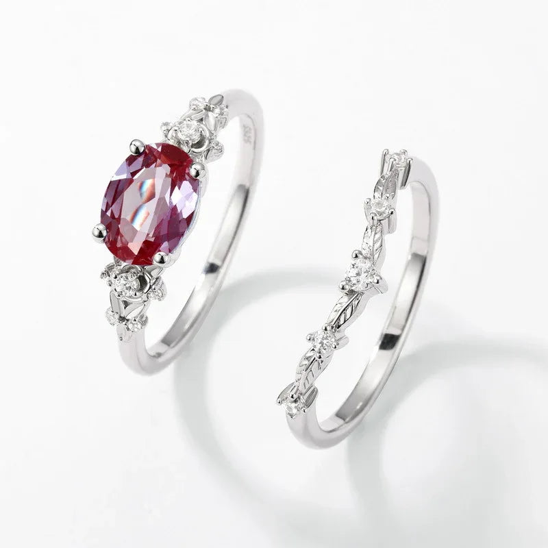 Oval Alexandrite floral three-band ring with clear accents, separated ring set shown on a white background