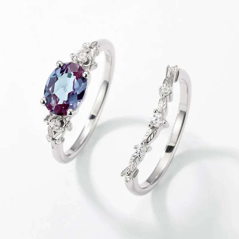 Oval Alexandrite floral three-band ring with clear accents, alternate separated ring set shown on a white background