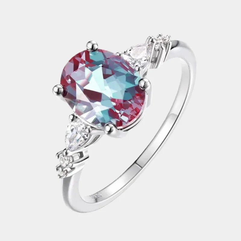 Oval Alexandrite leaf bypass ring with clear accents, front product view on a white background