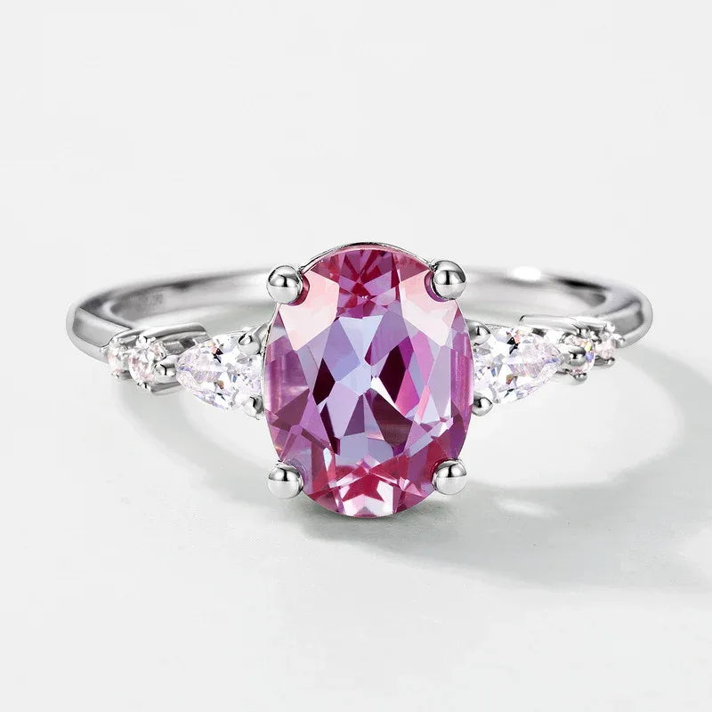 Oval Alexandrite leaf bypass ring with clear accents, pink-toned Alexandrite view under alternate lighting